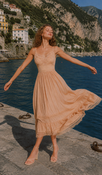 Model wearing the Champagne At Sunset Dress with a flowing silhouette on the Amalfi Coast, capturing effortless coastal elegance and feminine charm.