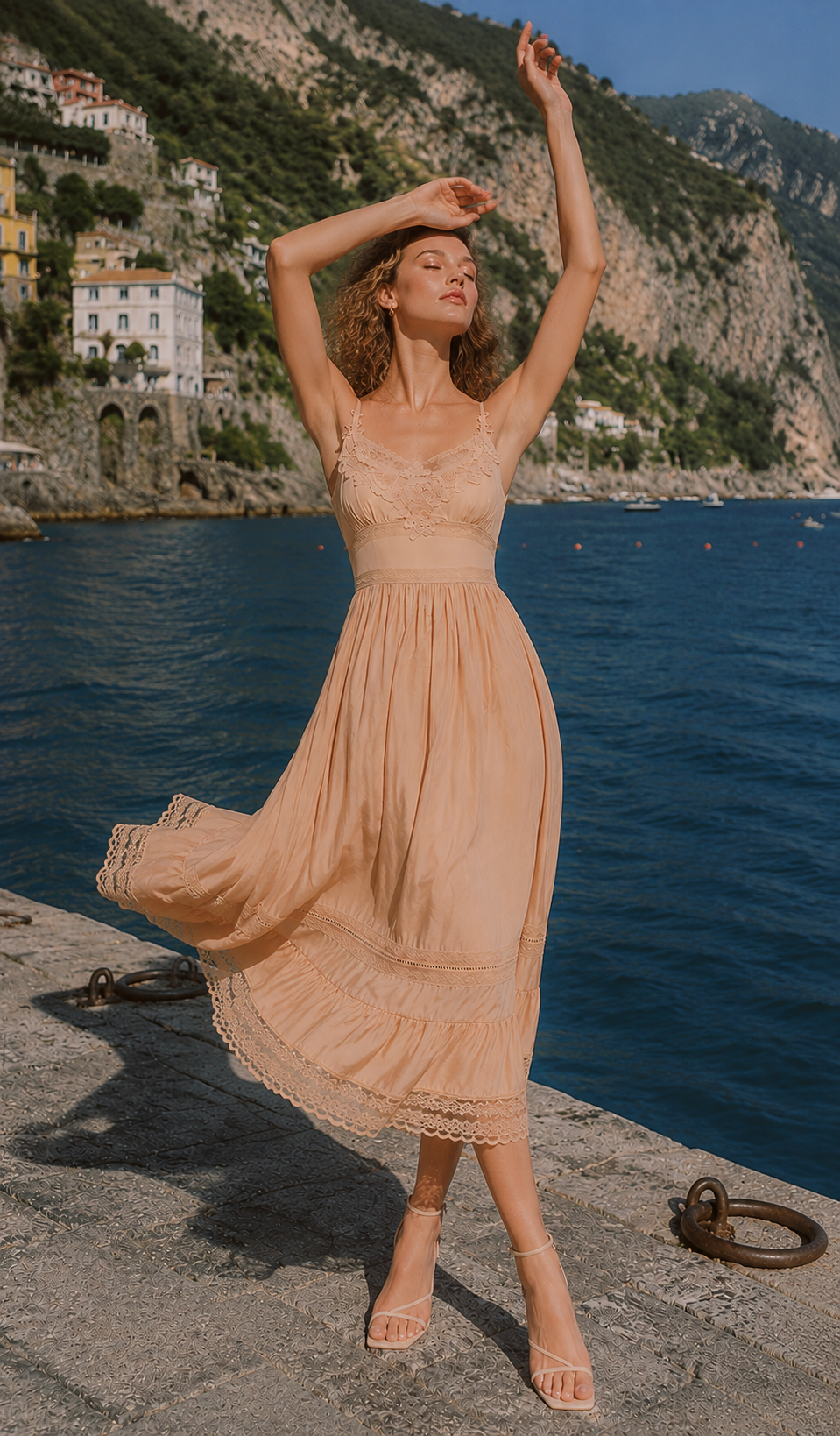 Model twirling in the Champagne At Sunset Dress along the Amalfi Coast, highlighting the flowing skirt, lace trim, and timeless romantic elegance.
