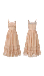 Front and back view of the Champagne At Sunset Dress displaying the elegant lace bodice, adjustable straps, fitted waist, and flowing lace-trimmed midi skirt.