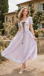 Model twirling in the Letters From Villa Fiora Corset Dress, showcasing the flowing lavender chiffon skirt, lace corset waist, and feminine silhouette.