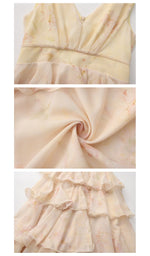 Close-up details of the Lilies Before Sunset Dress highlighting the delicate floral print, soft chiffon fabric, elegant waistline, and cascading tiered ruffle construction.