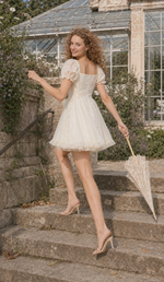 Back view of the Morning in Annecy Corset Dress (Short) as the model walks up greenhouse steps