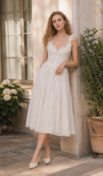 Model styling the The Forgotten Bride Corset with the lace straps worn off the shoulders, featuring elegant floral lace and a romantic vintage-inspired look.