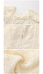 Close-up details of the bow, back zipper and textured fabric on The Last Promise of Ravello Dress