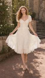 The Last Promise of Ravello ivory midi dress with flowing layered skirt in a Mediterranean garden