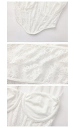Close-up details of The Last Vow Corset in white, highlighting embroidered floral lace, structured boning, supportive cups, and refined bridal-inspired craftsmanship.