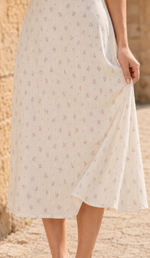Close-up of the flowing floral skirt, vertical fabric texture and finished hem of The Rosekeeper of Gordes Dress.