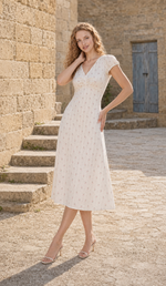 Three-quarter view of The Rosekeeper of Gordes Dress, an ivory rose-print midi dress with a fitted waist.