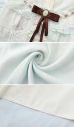 Close-up details of the The Sixth Summer Corset Dress highlighting the lace neckline, decorative ribbon brooch, soft chiffon fabric, delicate stitching, and premium craftsmanship.