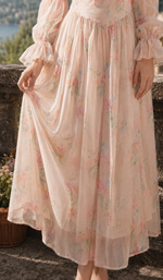 Close-up of the flowing watercolor floral skirt and lightweight layered fabric