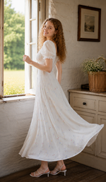 Front view of a white cottagecore floral maxi dress featuring puff sleeves and a flattering fitted bodice.