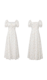 Front and back view of a white floral puff sleeve maxi dress with a square neckline and elegant full-length silhouette.